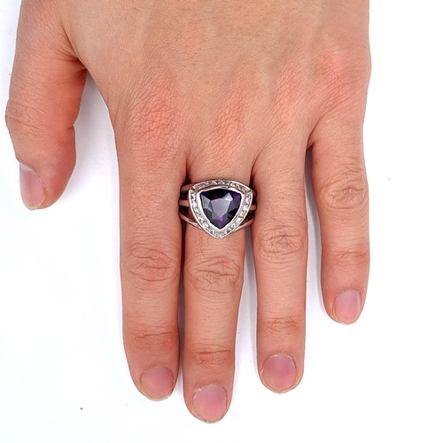 669 - A sterling silver amethyst stone ring with gem set surround, size Q, weight 10.7 grams, boxed.