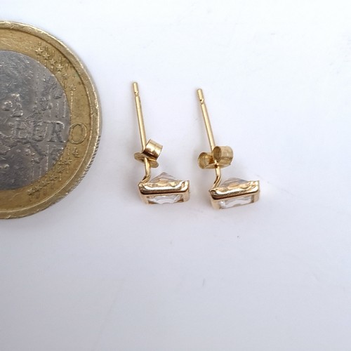 671 - A pair of 9K gold stud earrings set with gem stone mounts, boxed.