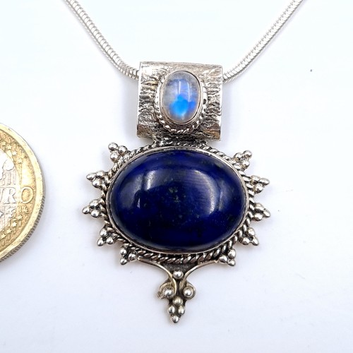 674 - A beautiful lapis lazuli cabochon and Moonstone pendant with silver chain, length 38cm.