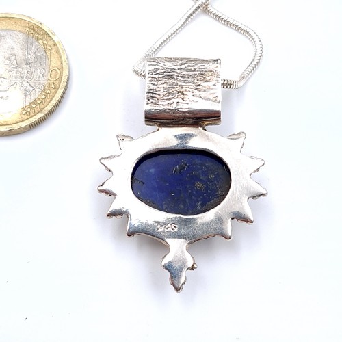 674 - A beautiful lapis lazuli cabochon and Moonstone pendant with silver chain, length 38cm.