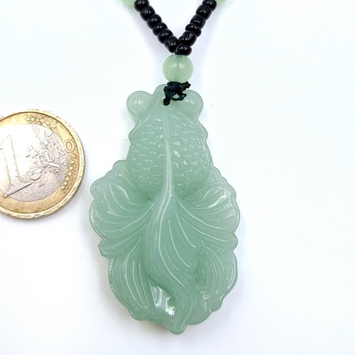 675 - An attractive jade pendant necklace, length 66cm, weight 39.5 grams. Stones cold to the touch