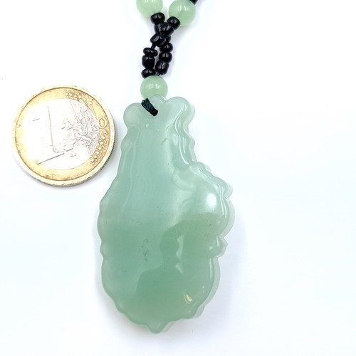 675 - An attractive jade pendant necklace, length 66cm, weight 39.5 grams. Stones cold to the touch