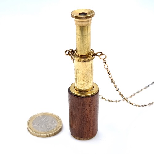 677 - An unusual brass stanhope telescope together with chain, length of chain 72cm.