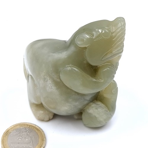 685 - An antique carved jade figure depicting two animals, dimensions 6cmx6cm, weight 142 grams.
