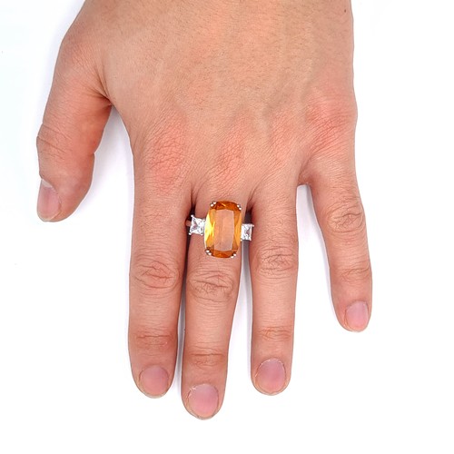 688 - An orange tourmaline stone ring with gem set shoulders set in sterling silver, size T, weight 6.26 g... 