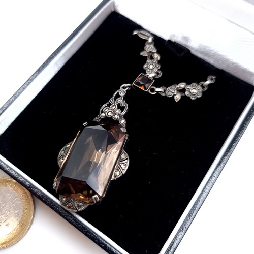 698 - An attractive vintage pendant necklace set with a smoky quartz stone with maracasite detailing, leng... 