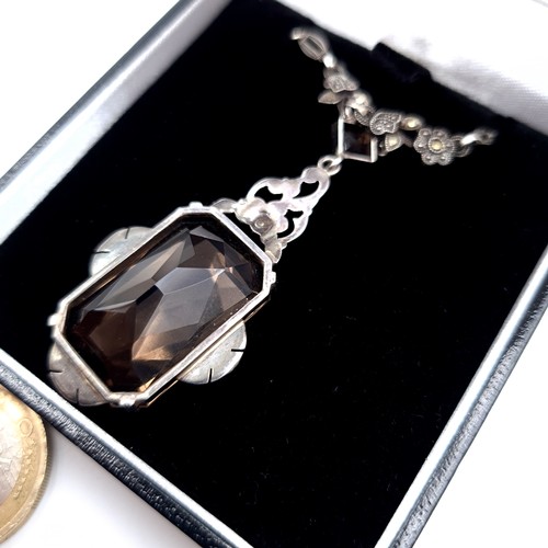 698 - An attractive vintage pendant necklace set with a smoky quartz stone with maracasite detailing, leng... 