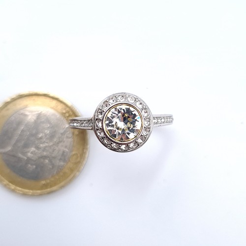 699 - A moissanite stone ring with cluster set Sterling Silver mount, ring size O, weight 3.77 grams.