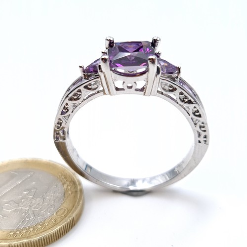 701 - An amethyst stone ring set with amethyst shoulders, mounted in sterling silver,  size V, weight 4.12... 