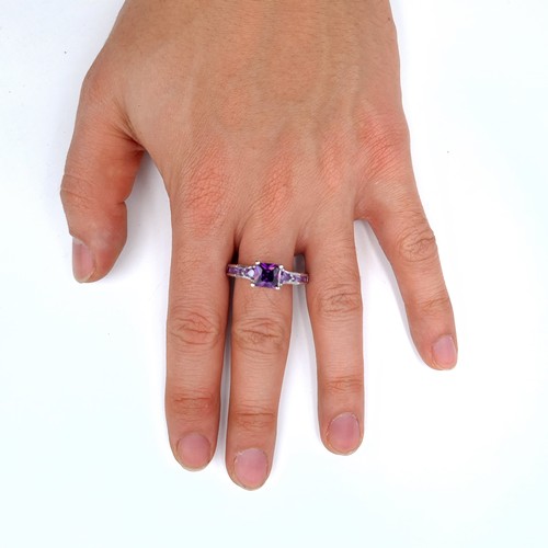 701 - An amethyst stone ring set with amethyst shoulders, mounted in sterling silver,  size V, weight 4.12... 