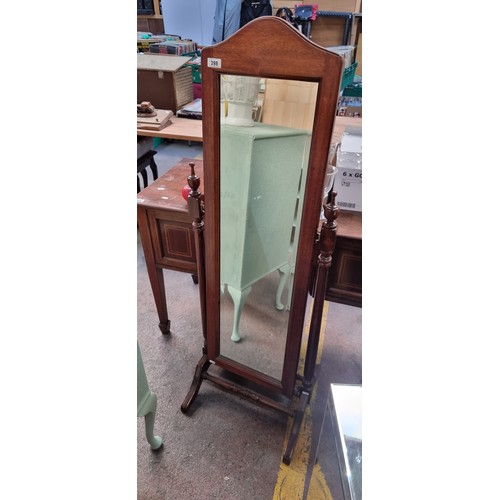 398 - A timeless floor standing full-length mirror with bevelled glass and rotating panel. From D. Higginb... 