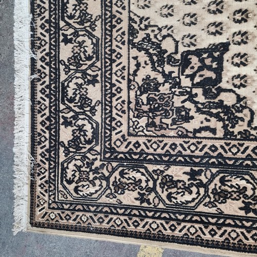 426 - Star lot : A large hand woven Persian style rug boasting an intricate geometric and foliate pattern ... 