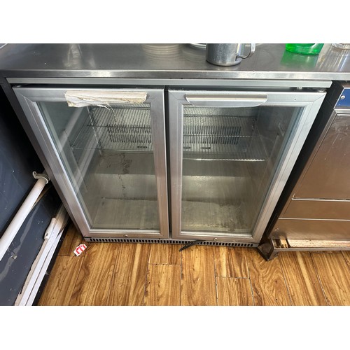 829 - Star Lot : A good clean Stainless Steel glass double door fridge. In excellent working order. The bu... 