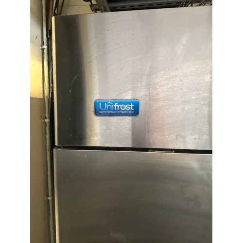 837 - Star Lot : A large double door Unifrost Stainless Steel Fridge with 3 white racks inside. Fully work... 