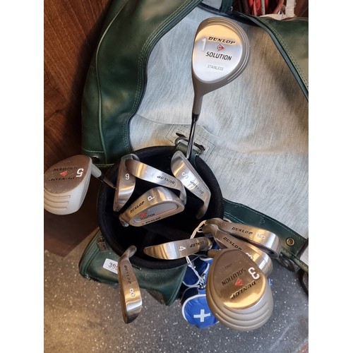 277 - A collection of 11 Dunlop Solution golf clubs including 5 and 3 woods, a driver, S and P wedges and ... 