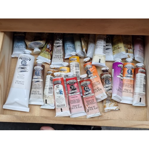 370 - Two artists boxes pack full of paint tubes and brushes. Mostly consisting of Winsor and Newton. This... 