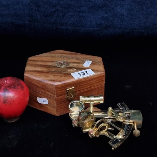 137 - A lovely brass sextant with glass lenses. Comes with a maritime themed wooden case.