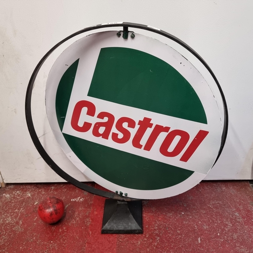 156 - A rotating metal Castrol advertising sign held on heavy cast metal base.