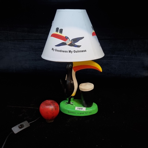 189 - A cheerful Guinness advertising table lamp with a base in the form of the iconic toucan.