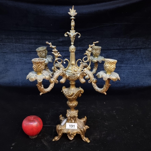 191 - A striking antique very heavy brass candelabra with four branches and highly ornate foliate detailin... 