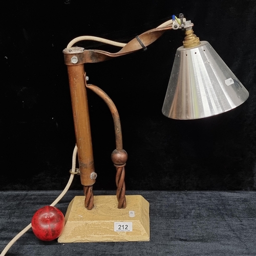 212 - A highly unusual abstract copper lamp complete with chrome shade and sat on a stone base. Originatin... 