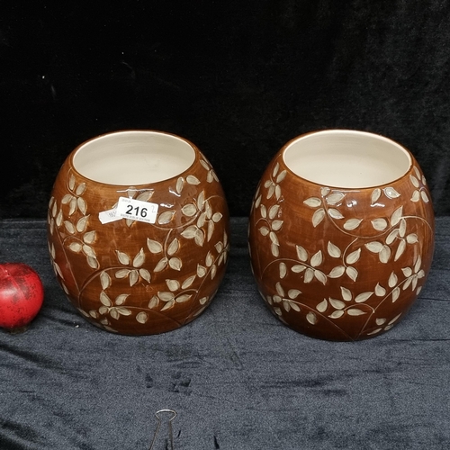 216 - A beautiful pair of Oslo studio pottery vases boasting a rich vibrant brown glaze with gorgeous flor... 