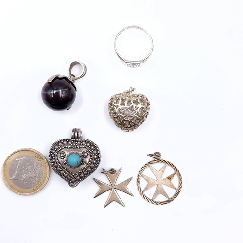 444 - A collection of six Silver items consisting of five pendants, some marked sterling silver together w... 