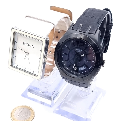 446 - A Nixon stainless steel leather strap wristwatch together with a Swatch water resistant example.