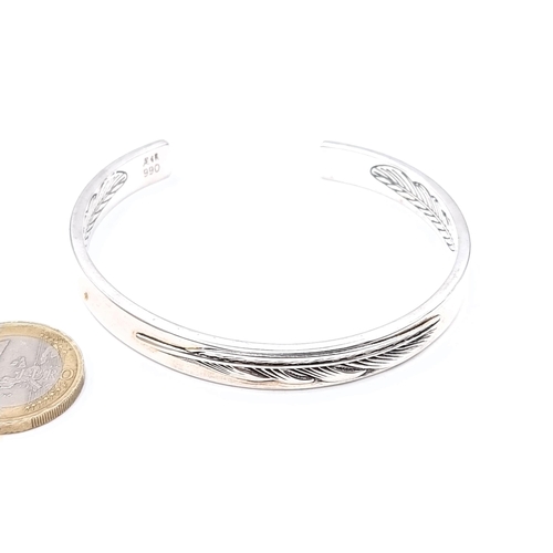 458 - A high grade silver bracelet with leaf design to inner band set with a love inscription. Weight 23.6... 