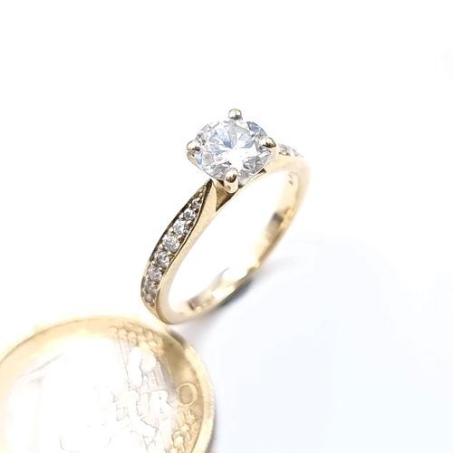 476 - Star Lot : A fine example of a moissanite solitaire ring set in 9K gold (375) with diamond set shoul... 