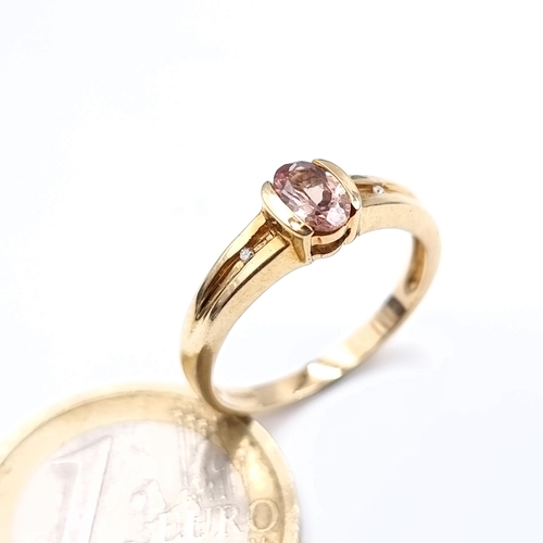 484 - A nice example of a 9K gold (375)  tourmaline stone ring with diamond accents, ring size o, weight 2... 