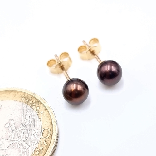 488 - A pair of black luster pearl stud earrings, set in 9K gold, total weight 1 gram.