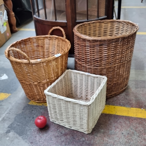 551 - Three wicker laundry baskets including one with handles.