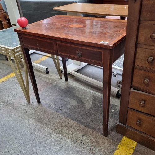 553 - An elegant Edwardian hall table with two drawers featuring ring handles and eye-catching string inla... 