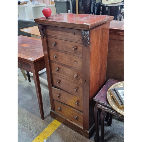 554 - A handsome Victorian  chest with 7 drawers and a swinging locking arm to side. Boasting foliate moul... 