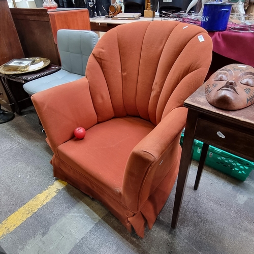 556 - A Vintage Oyster style art deco comfortable armchair in a terracotta finish. Featuring a shell-like ... 