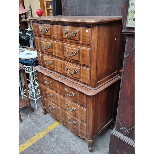 566 - Star Lot : An extravagant serpentine-front chest on chest with six full length drawers. H138cm x W99... 