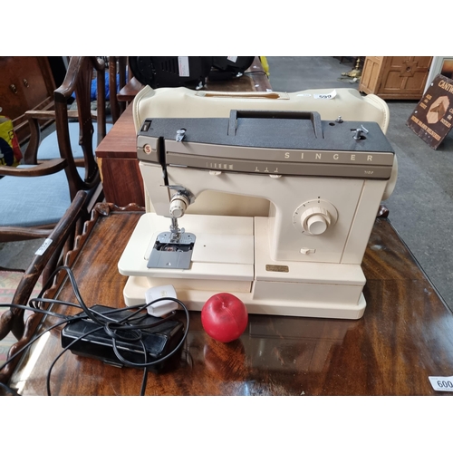 599 - A superb vintage Singer 7102 sewing machine complete with original pedal and protective leather case... 