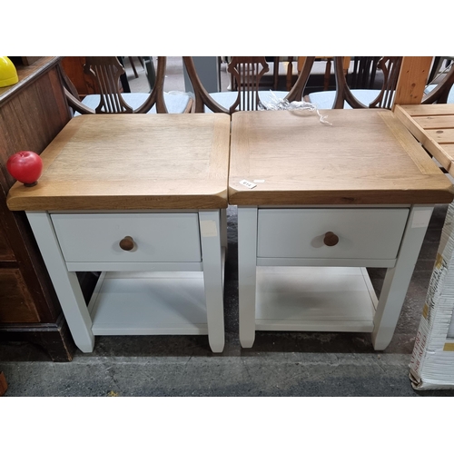 614 - A pair of as new well made contemporary bedside lockers featuring solid oak top and pull out drawer ... 