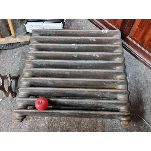 631 - Star Lot : A stunning and extremely heavy antique cast iron radiator with separate cast feet.