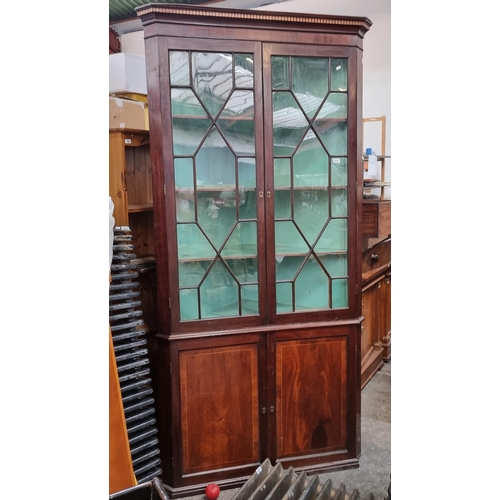 634 - A magnificent Jamaican Mahogany Georgian oak freestanding astra glazed two door corner cabinet boast... 