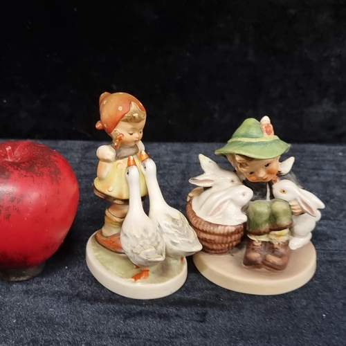 253 - Two adorable W. German Hummel pocelain figures. Both in excellent condition, stamped to base.