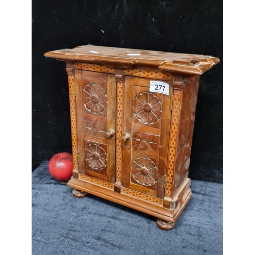 277 - A fabulous vintage counter / table top wooden cabinet featuring two doors to front opening to reveal... 