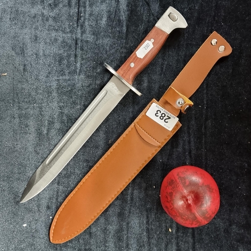 283 - An AK 47 CCCP fixed blade hunting knife, held in a tan leather sheath.