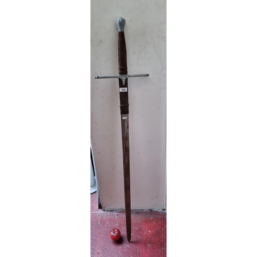 319 - A long and heavy broad sword with pewter hilt  and guard. Featuring suede handle.