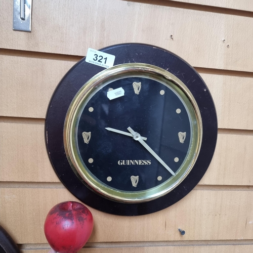 321 - A handsome Guinness advertising wall clock glass front and brass surround.