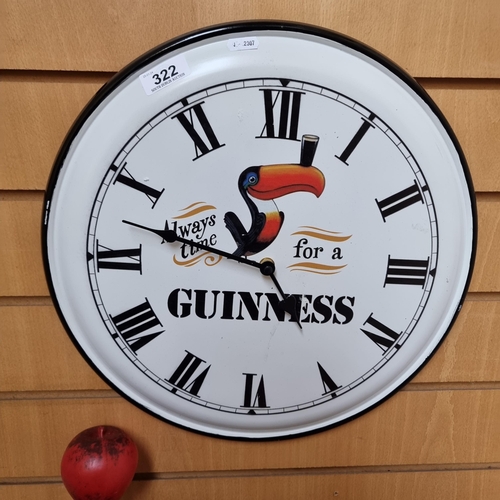 322 - A metal Guinness advertising wall clock reading 'Always Time For A Guinness'.