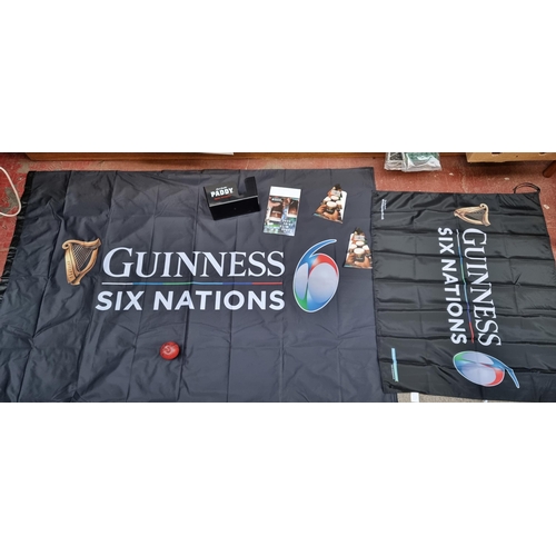 337 - A collection of five pub advertising items. Including two Guinness flags, a Paddy Irish Whiskey pub ... 