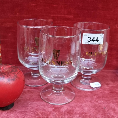 344 - Three rare vintage Guinness branded footed glasses in very good condition.