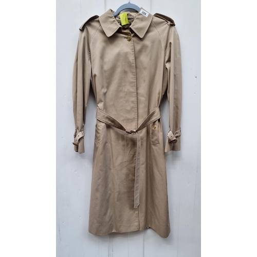 355 - Star Lot: A fabulous vintage designer Burberrys' trench coat. Featuring the iconic brand tartan desi... 